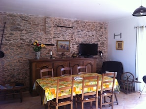 Enjoy meals in this cozy dining area with a wooden table and comfortable seating for six.