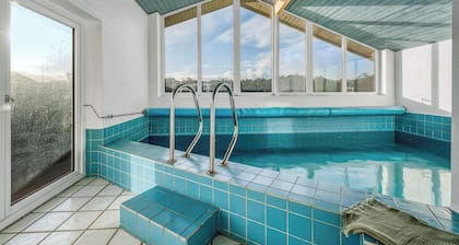 Lovely holiday home with pool, spa and sauna, only 200 meters from the North Sea.