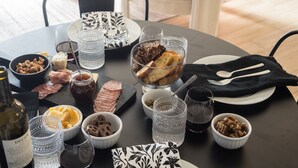 A dining table set with various food items, glasses, and cutlery.