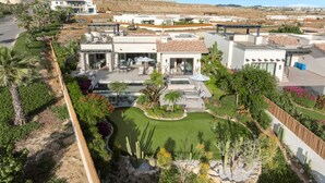 A residential area with modern houses, a swimming pool, and landscaped gardens. - Stunning Oceanview 3-Bedroom (Cabo San Lucas)