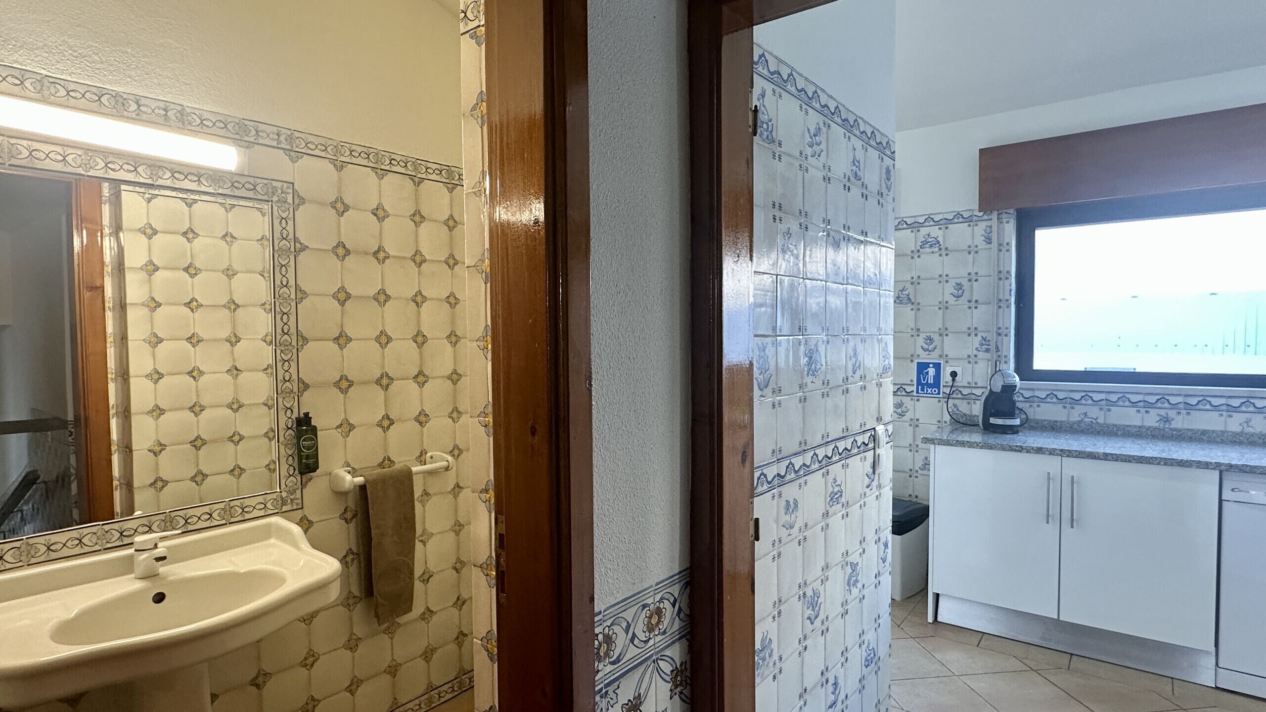 A bathroom with a sink, mirror, and towel rack.
