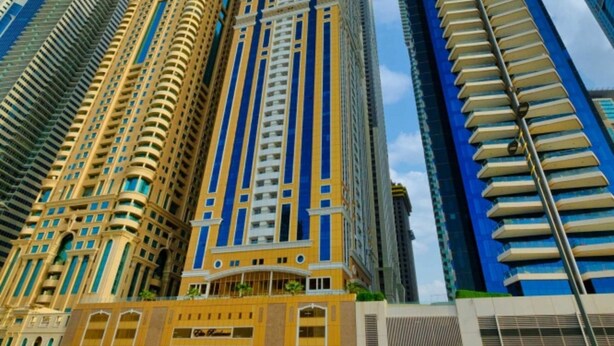 A high-rise building with a prominent entrance and multiple floors.