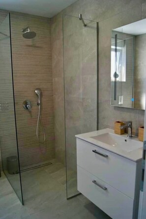 Shower, hair dryer, towels, toilet paper