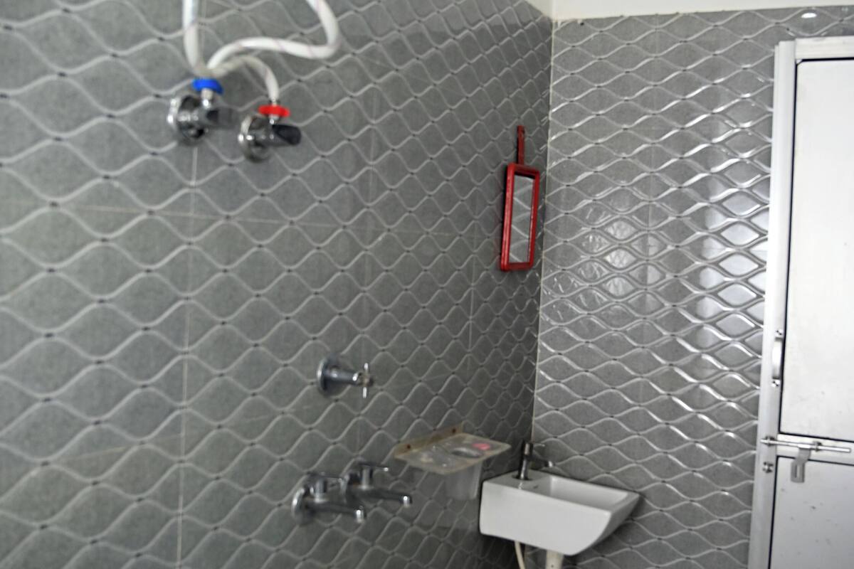 A bathroom with a shower, a sink, and a toilet.