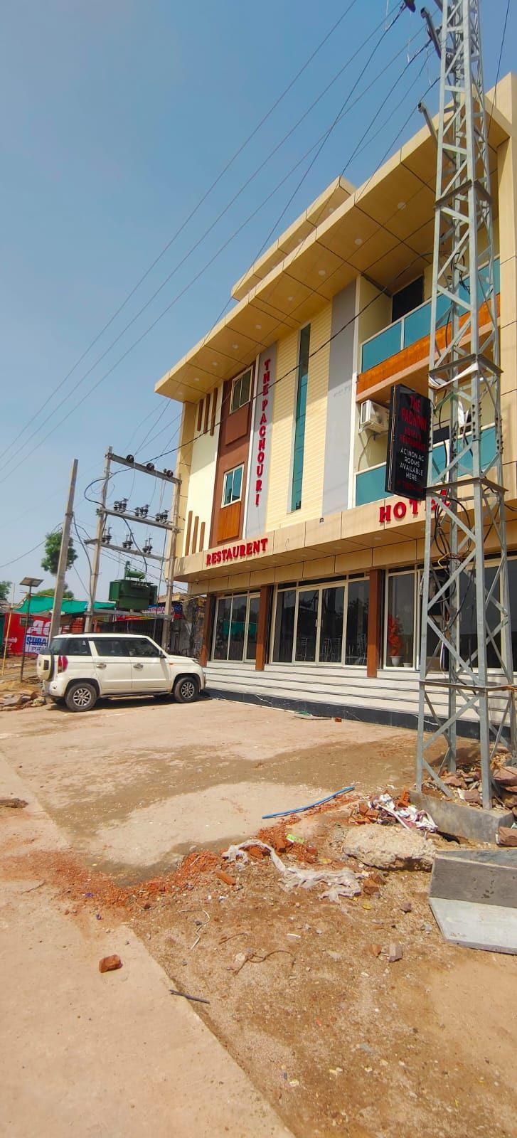 A two-story building with a sign for 'The Pachauri Restaurant' and 'HOTEL'.