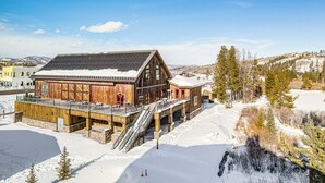 A wooden building with a large deck and stairs leading to a covered area. - Near Hiking & Biking: Winter Park Mtn-view Haven! (Winter Park)