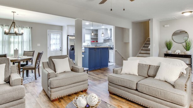 A spacious living room with two sofas, a dining table, and a kitchen in the background. - 6 Mi to The Masters: Updated Home w/ Yard! (Augusta)