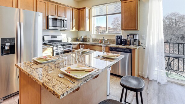 A modern kitchen with granite countertops, stainless steel appliances, and wooden cabinets. - 4 Mi to Dtwn: Family-friendly Townhome in Reno (Reno)