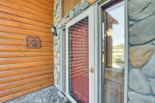 A wooden exterior with a stone wall and a red door. - 3 Mi to Dtwn: Mtn-view Red Lodge Retreat! (Red Lodge)