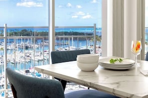 Uma mesa de jantar com vista para um porto e barcos.