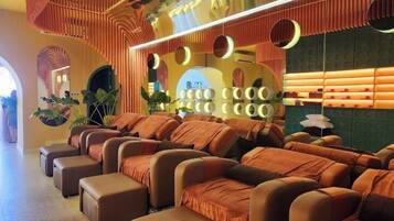 Relax in comfort with our massage chairs, surrounded by soothing ambiance and lush greenery.