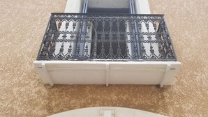 A balcony with ornate metal railings and a white balustrade. - Village house close to the lagoon and the sea (Marseillan)