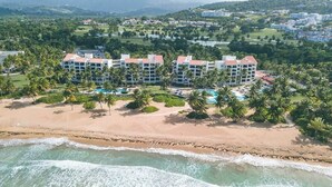 Un complexe hôtelier comprenant plusieurs bâtiments, une plage et un espace piscine.