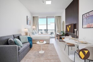 Luxury Studio, City View | Living area | 55-inch Smart TV with satellite channels - Vogue | Luma22 West Jumeirah Village Circle near Circle Mall (Dubai)