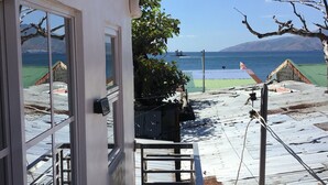 A balcony with a view of the sea, a satellite dish, and a metal railing. - Perfect getaway beach resort with a great view of Subic bay  (Olongapo)