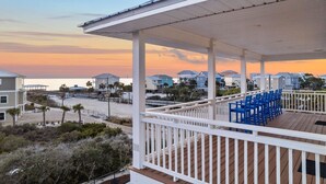 A beachfront property with a covered deck and beach chairs. - Pool | Gulf Views | Outdoor Shower (Port St. Joe)
