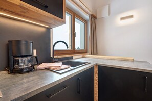 Fridge, stovetop, dishwasher, coffee/tea maker