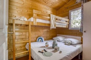 Cozy cabin room with a bunk bed and single bed, perfect for a comfortable stay.