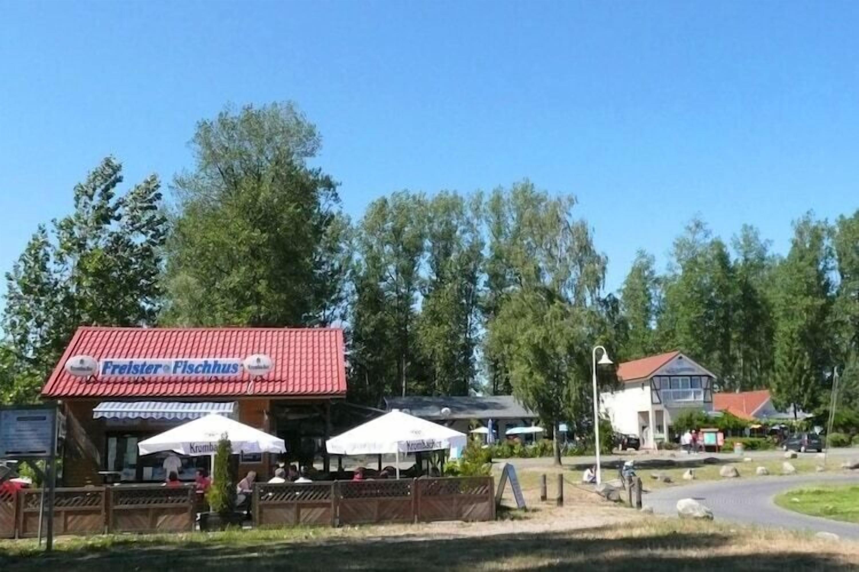 Un restaurant appelé « Freister Fischhaus » qui dispose d’une terrasse et de parasols.