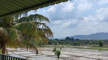 Enjoy breathtaking views of the surrounding landscape from this balcony.