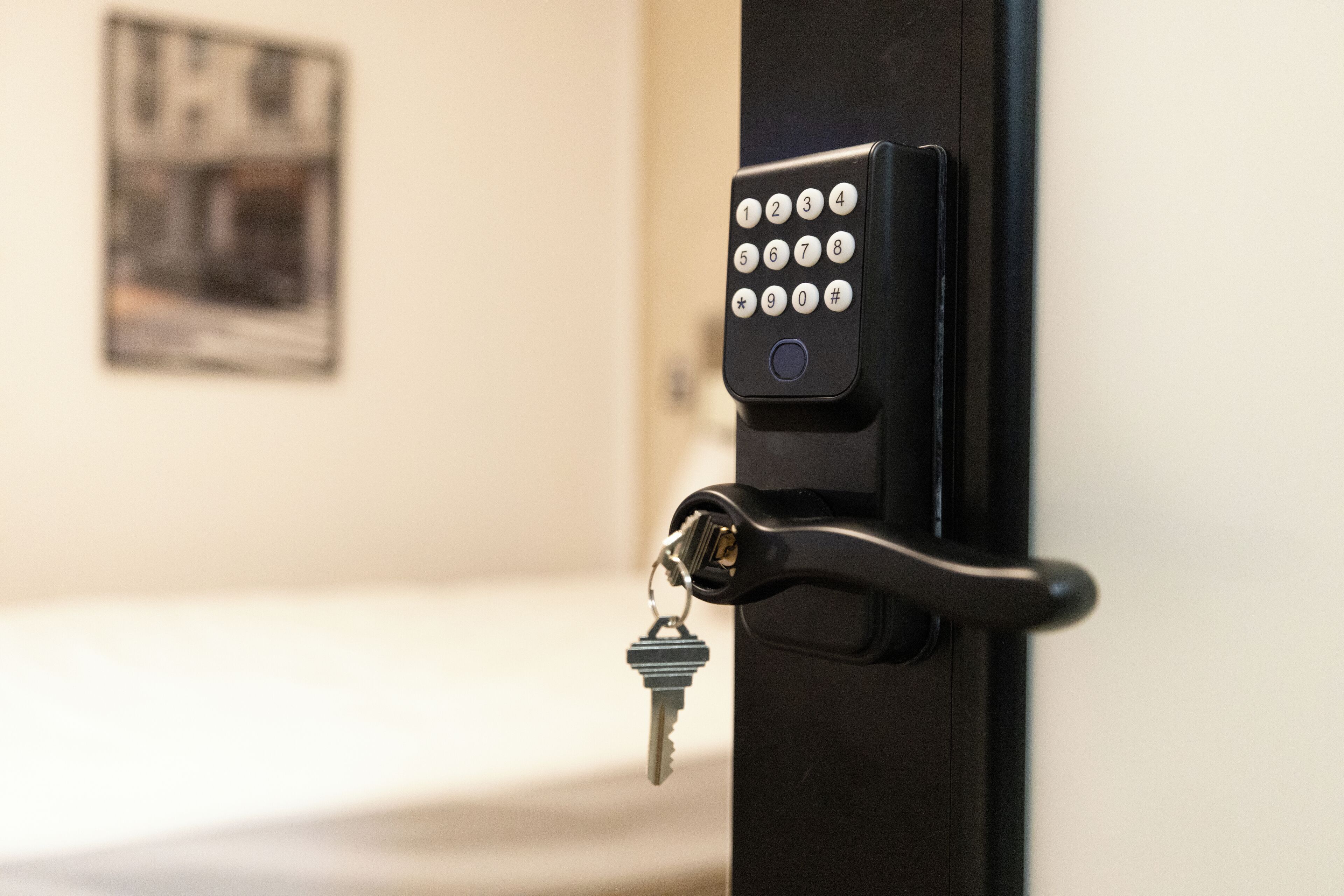 A door with a numeric keypad lock and a key inserted.