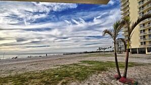 A beach with a building in the background.