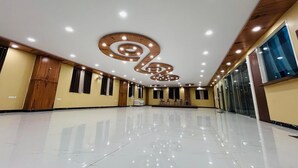 A spacious, well-lit hotel lobby with a polished floor, wooden paneling, and a modern ceiling design. - HOTEL INDRALOK INN (Hazaribagh)