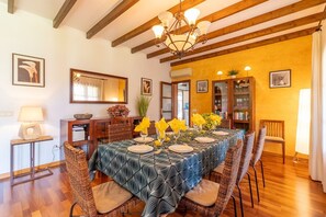 A dining area with a table set for four, surrounded by wicker chairs, a chandelier, and a wooden ceiling. - Villa 'Mil Flores, Purer Luxus' with Mountain View, Wi-Fi and Air Conditioning (Inca)