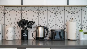 A kitchen counter with a coffee maker, toaster, and utensils. - @ Marbella Lane - Serene and Pristine Home (West Covina)