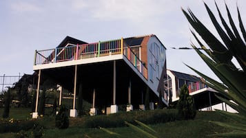 A modern house with a unique architectural design, featuring a multi-level structure and a prominent staircase.