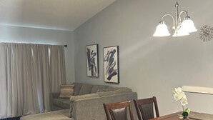 A dining area with a wooden table and chairs, a ceiling fan, and a chandelier. - ★12Mins to Disney Theme Parks- Save 25pct Off Stay- Pool- 3BR Condo-Sleeps 10★ (Kissimmee)