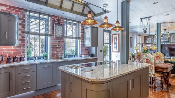 A spacious kitchen with a large island, grey cabinets, and a brick accent wall. - The Catacombs-barbican - Pet Friendly - 5 Guests (Plymouth)