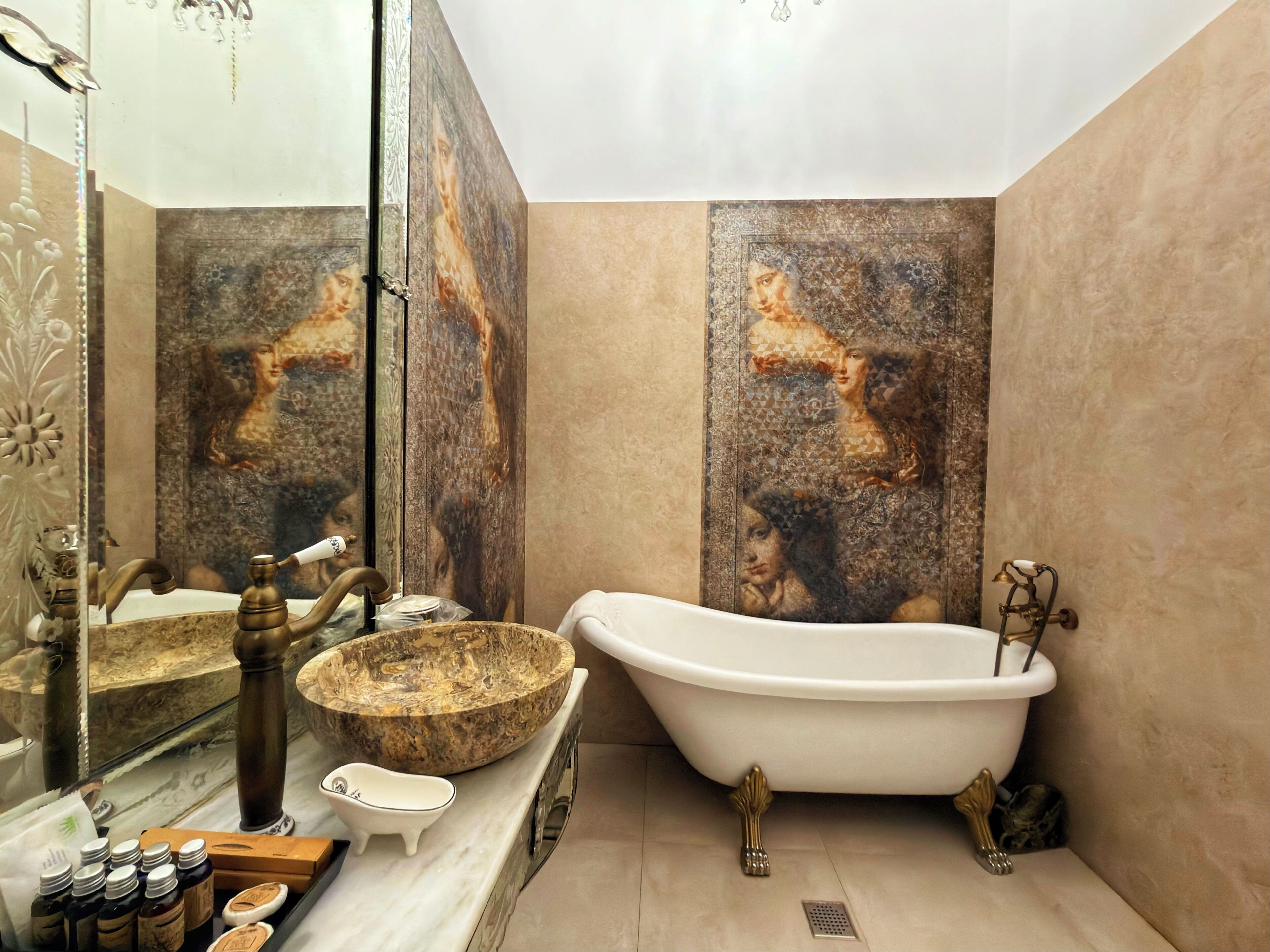 Un baño con una bañera independiente, un espejo grande y un panel decorativo en la pared.