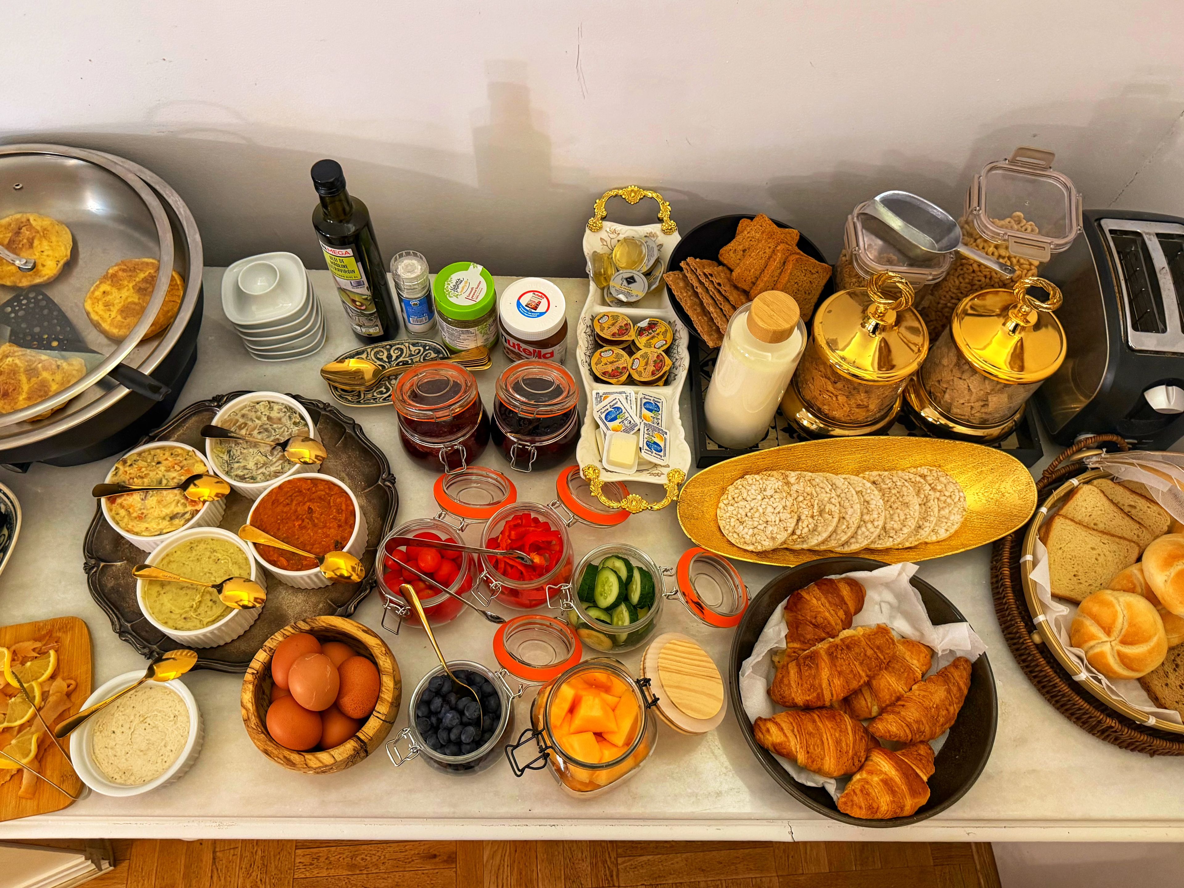 A breakfast buffet with various food items and condiments.