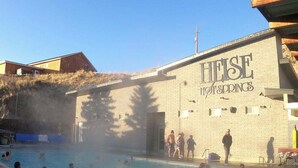 A swimming pool area with a building labeled "HEISE HOTSPRINGS" in the background.