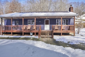 Enjoy a cozy cabin with a covered porch, perfect for relaxing and taking in the surroundings.
