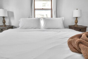 Restful retreat with a view, featuring a comfortable bed and bedside tables.