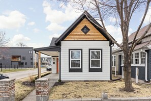 A small, single-story house with a gabled roof, a front porch, and a visible address number. - Sunny Blue: 4 BR, 2 En-suites, Hip Fountain Square (Indianapolis)