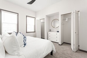 A bedroom with a bed, dresser, and closet. - Sunny Blue: 4 BR, 2 En-suites, Hip Fountain Square (Indianapolis)