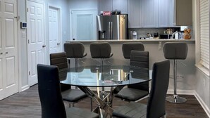 A modern kitchen with a central island, stainless steel appliances, and pendant lighting. - Mountain Ferry Landing - Riverfront Access (Charles Town)