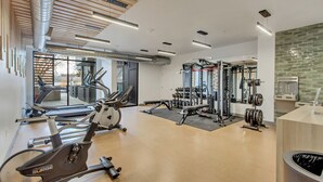 A modern gym with cardio equipment, weight machines, and a mirrored wall. - LCF - Sugarhood - Sugar House- 3BR/2BA - CoWork + Gym - 2 Kings + Queen (Salt Lake City)