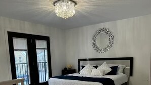 A bedroom with a bed, a chandelier, a white rug, and a white crib. - new house. built in 2022

 (Stratford)