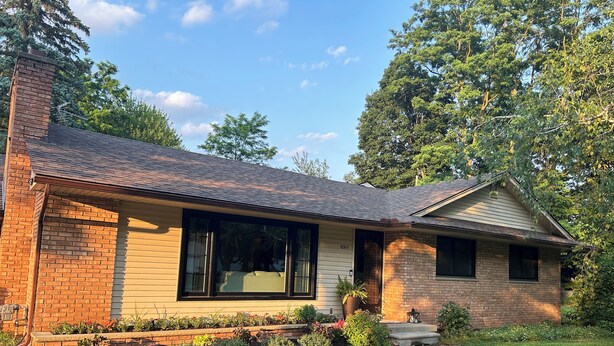A single-story house with a brick exterior, large windows, and a well-maintained lawn. - Spacious 3-bedroom house in beautiful Brighton. (Brighton)