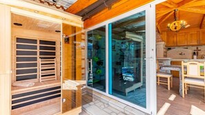 A wooden interior with a sliding glass door leading to a kitchen area. - Villa Azimut - Cozy Home In Medulin With Sauna (Medulin)