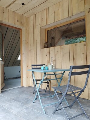 Cozy room with a sloped ceiling and a window offering a view.