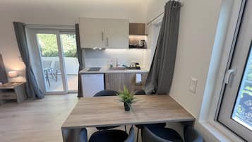 Comfort Quadruple Room, Mountain View | Living area | TV