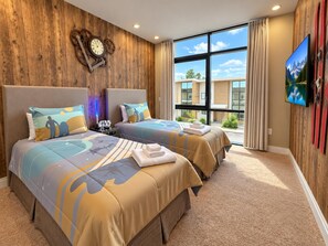 A hotel room with two beds, a large window, a clock on the wall, and a TV mounted on the wall. - Stay Near Disney Magic | Gorgeous 4BR Villa w BBQ (Kissimmee)
