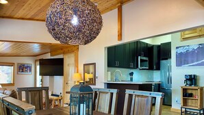 Una cocina moderna con armarios oscuros, electrodomésticos de acero inoxidable y una isla de madera.