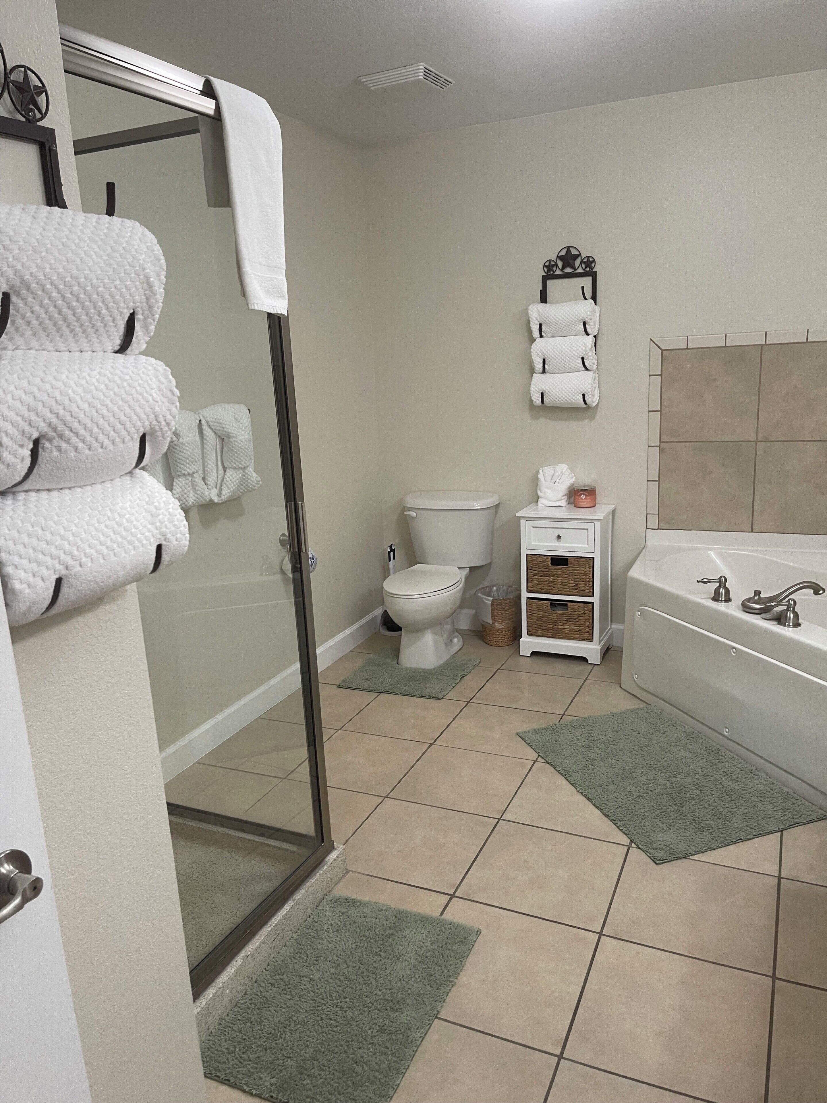 Shower, jetted bath, towels, toilet paper