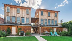 A two-story wooden house with a front porch, a grill, and a small garden. - Serendipity House: Historic Downtown Livingston Loft (Livingston)